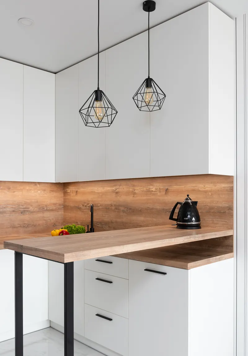 Geometric pendant lights above a kitchen worktop